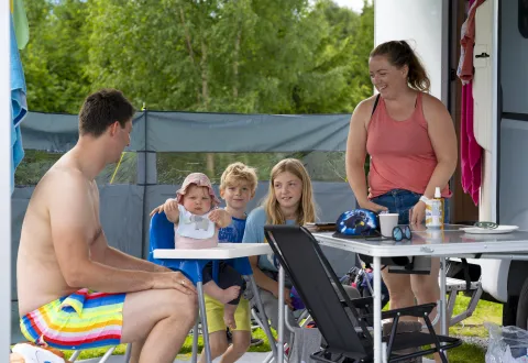 Familie koser seg på camping